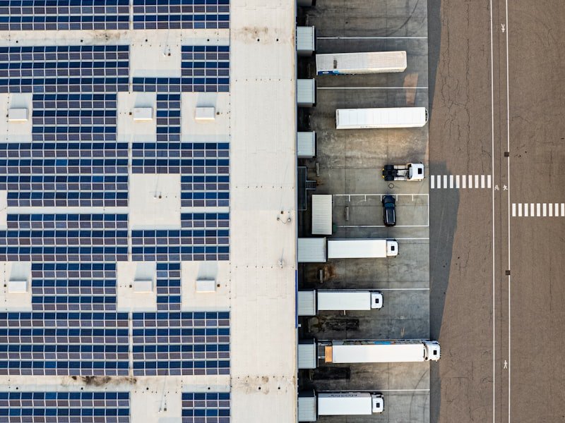 Aerial view of a commercial fleet yard with trailers at loading bays