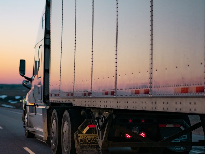 Freight trailer on highway at sunset — delivery route operations